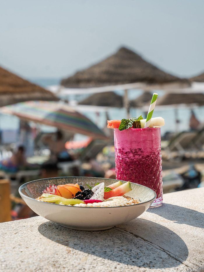 A berry smoothie on the beach wall.