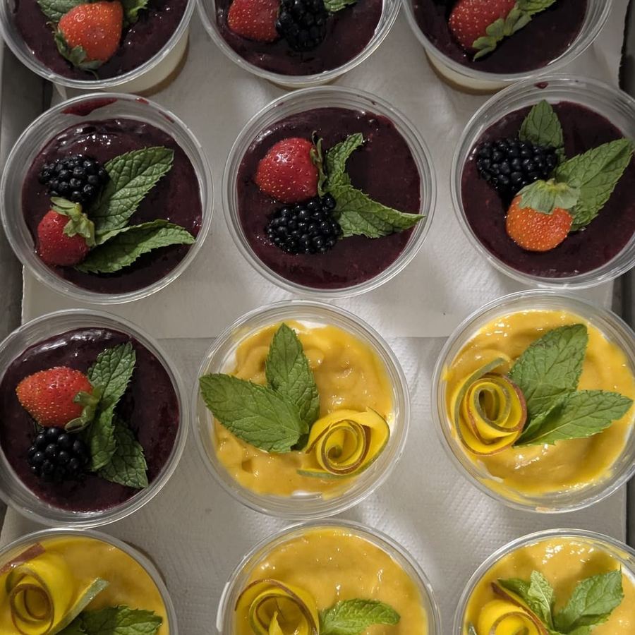 Individual dessert pots topped with fruit and mint.